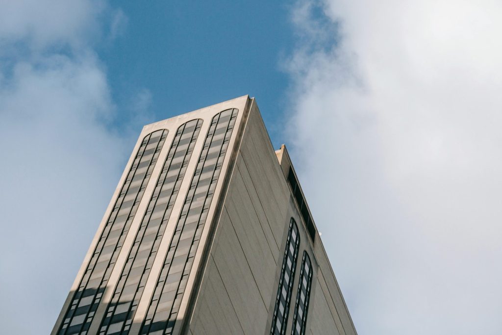 A modern skyscraper reaching into the clear blue sky, showcasing contemporary architecture.